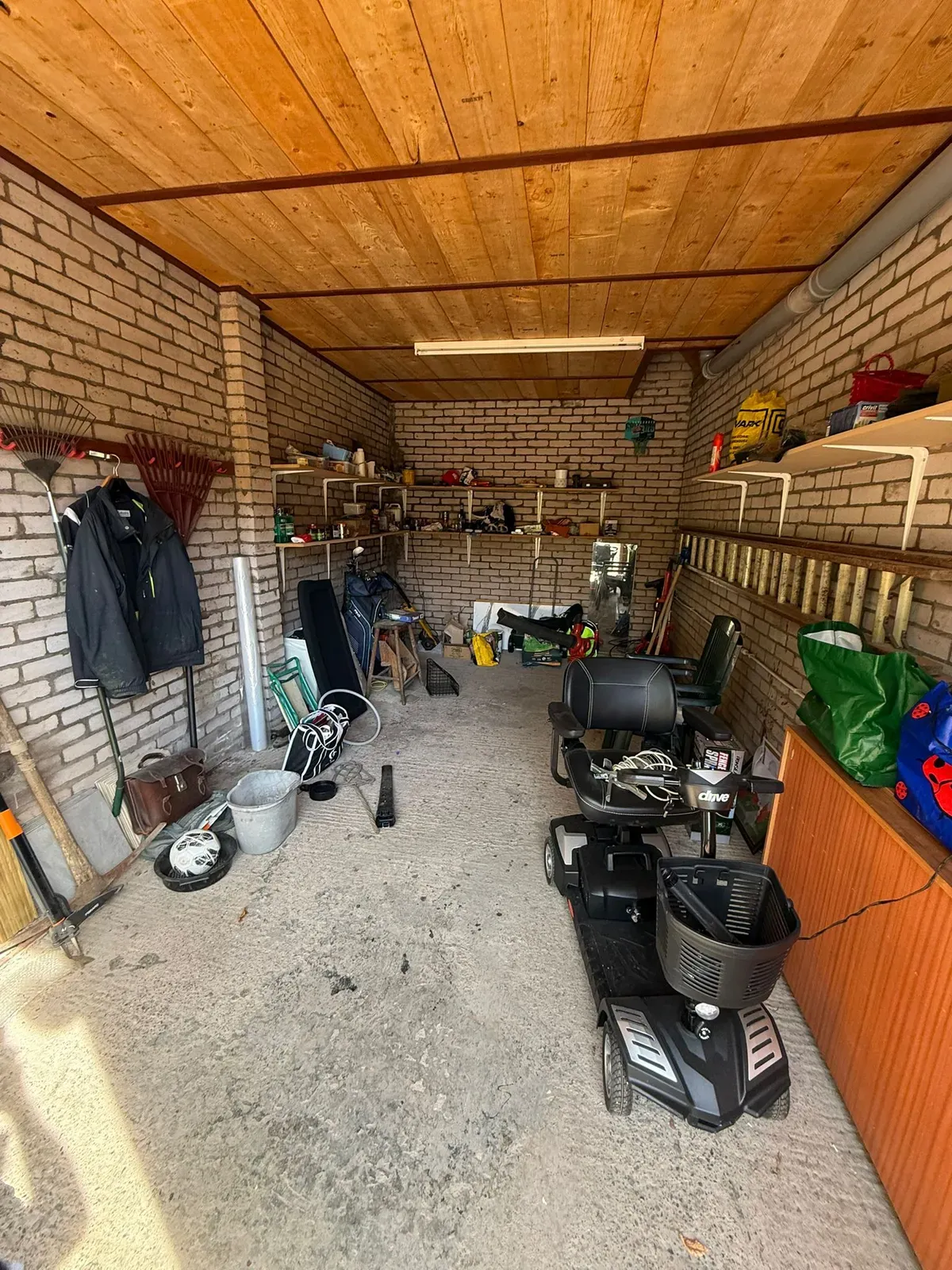A cluttered garage before a part clearance