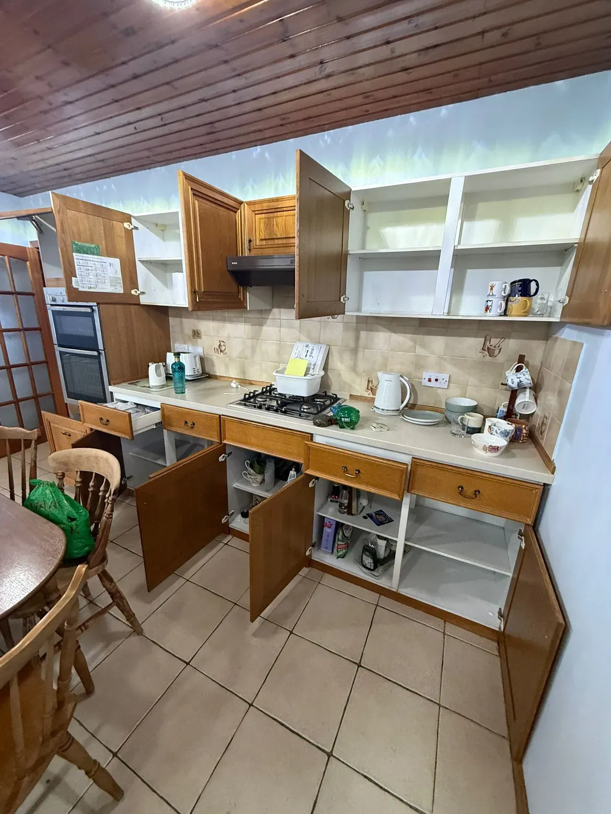 A kitchen mid-clearance with cupboards emptied