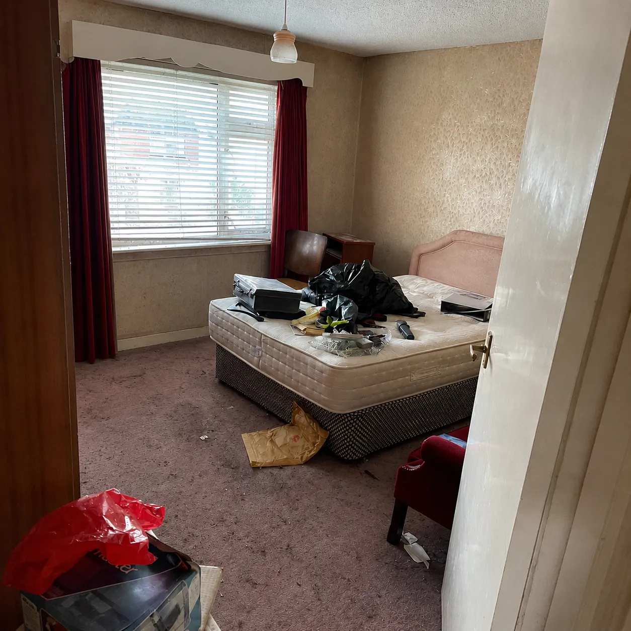 A lived-in bedroom before a house clearance